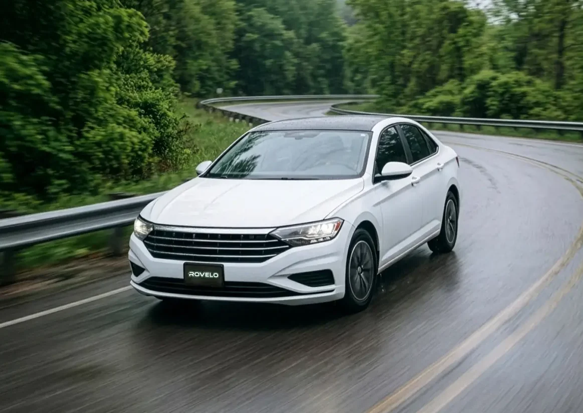 White car driving in spring on wet road