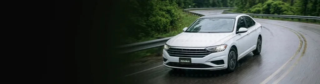 White car driving down road