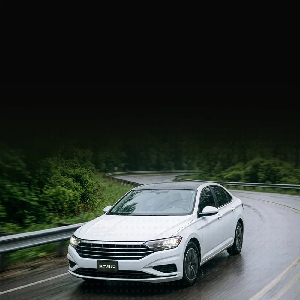 White car driving down road